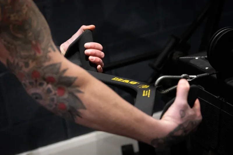 Hands gripping a MAG attachment showing the ergonomic contoured design