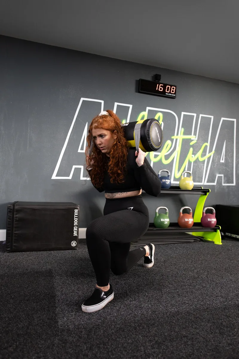 Reverse lunge with rotation using power bag