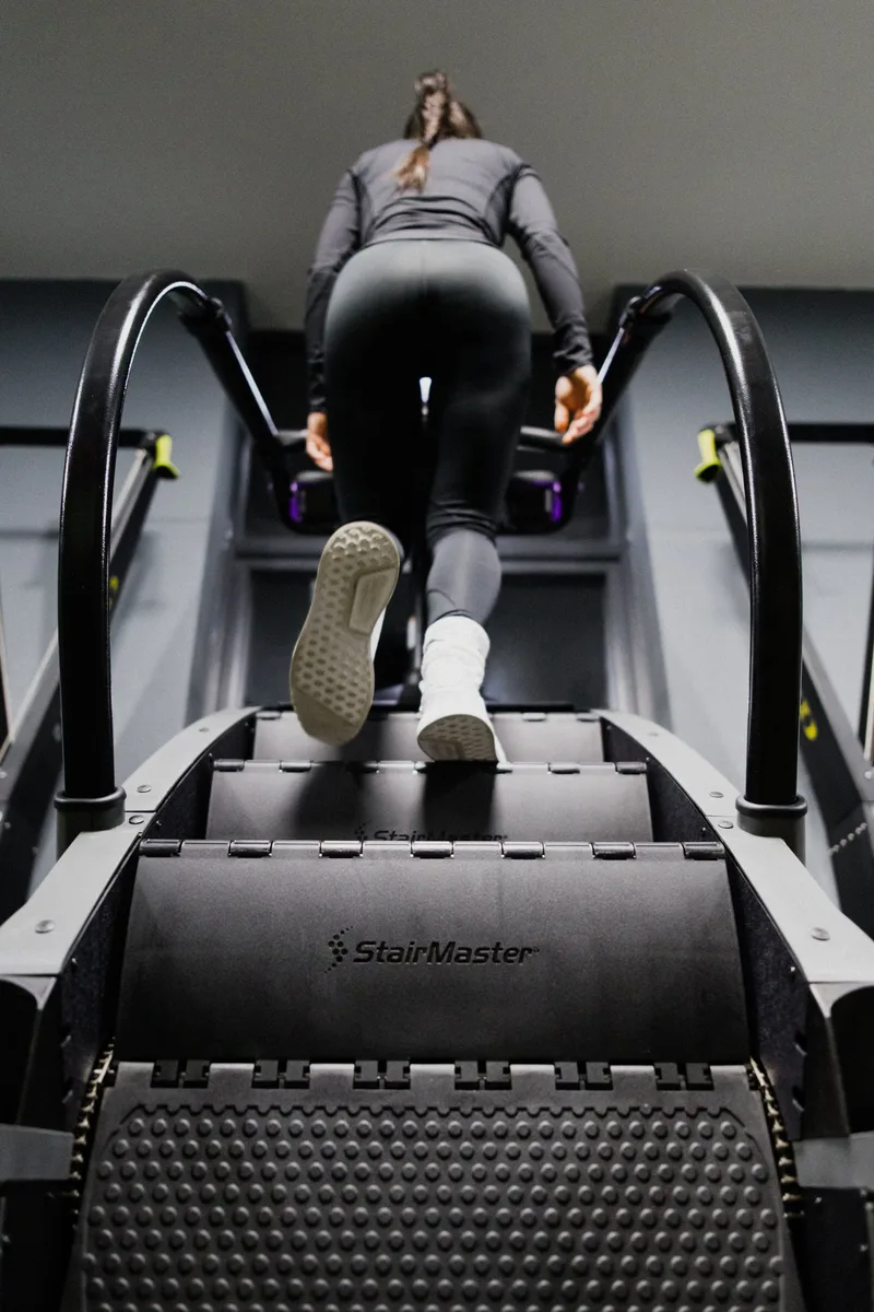 Member using the StairMaster at Alpha Athletic